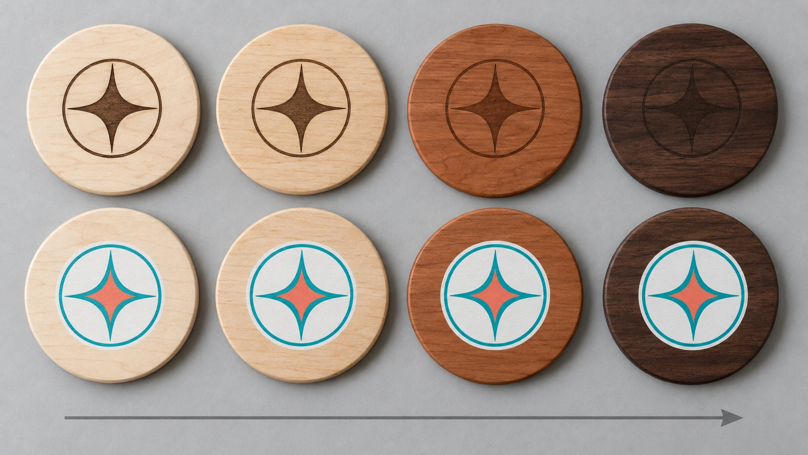 Row of round wood coasters from pale maple to dark walnut, each decorated with the same abstract emblem, showing engraving contrast fading on darker wood while printed color stays visible