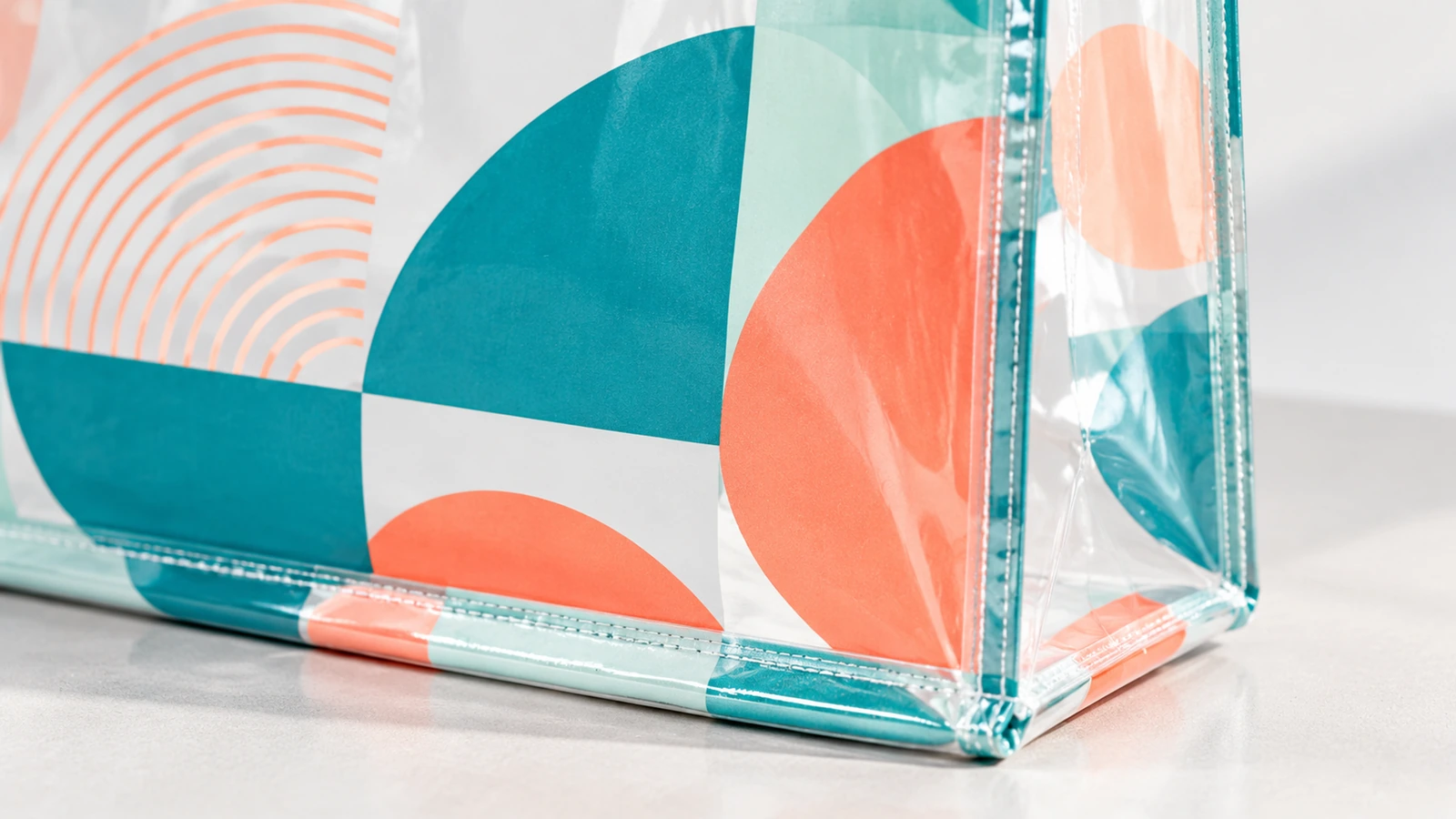 Transparent and frosted film swatches with open-top zipper and snap closure concepts including a rear fastening view