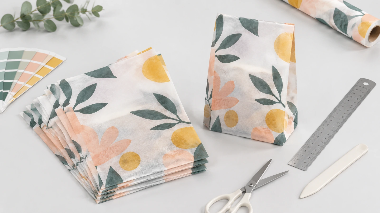 Translucent glassine merchandise bags with stationery and accessories on a retail packing table