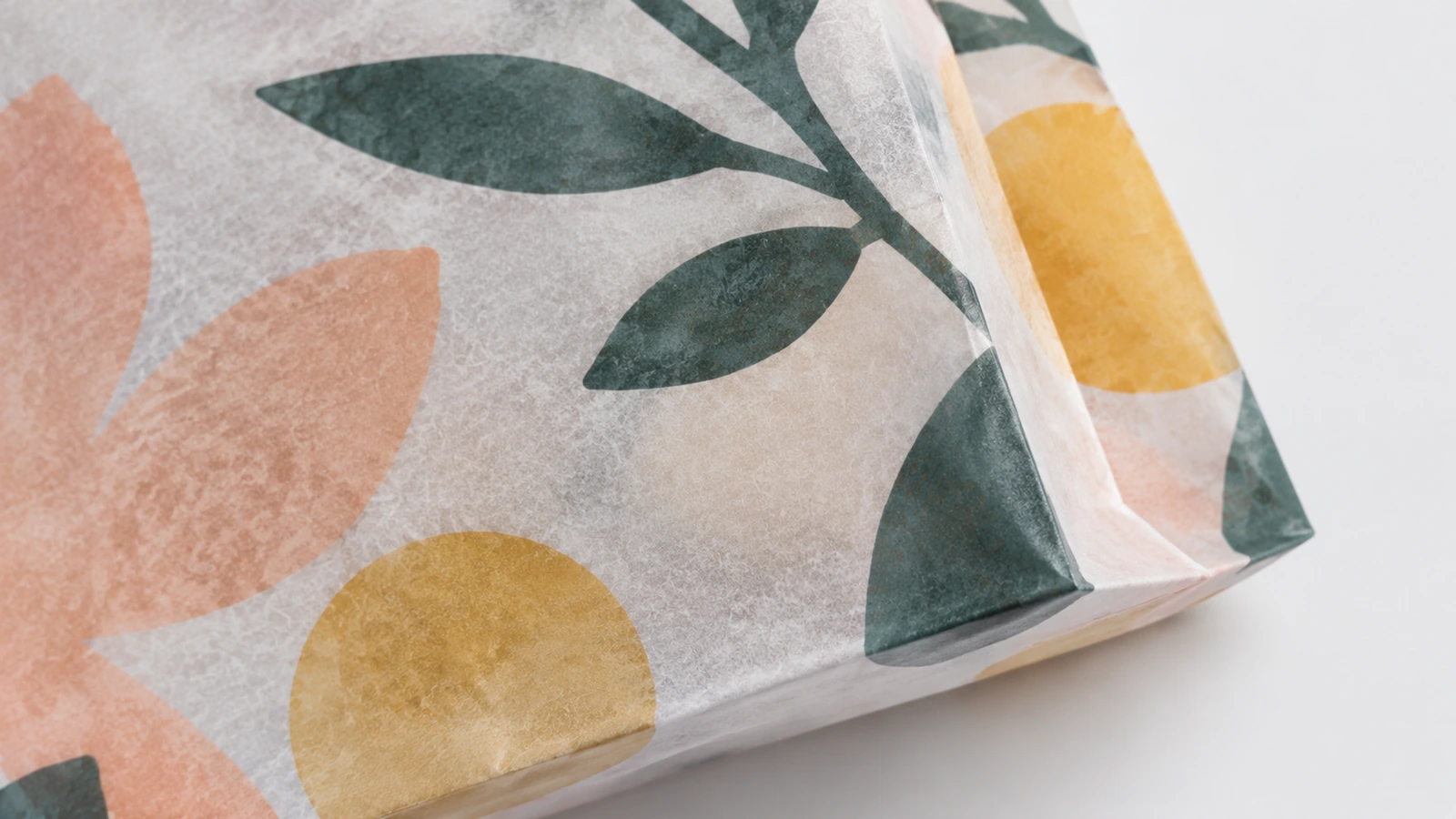 Glassine paper surface samples beside open-top, folded-flap and adhesive-flap bag concepts